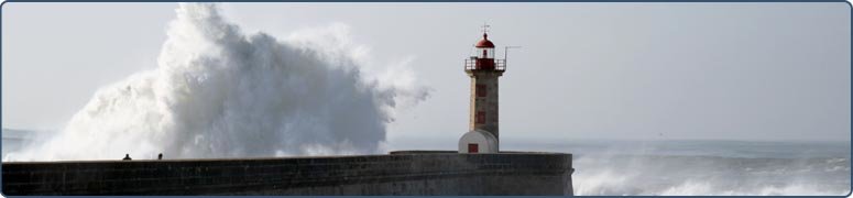 Lighhouse at end of pier, waves crashing